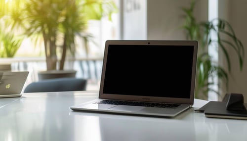 A laptop open on a nice desk.