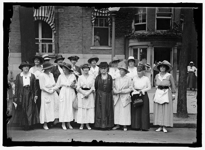 Women's suffrage group posing in front of their headquarters, circa turn of the century.